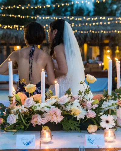 bride talking to her bridesmaid at her wedding with beautiful flower decor